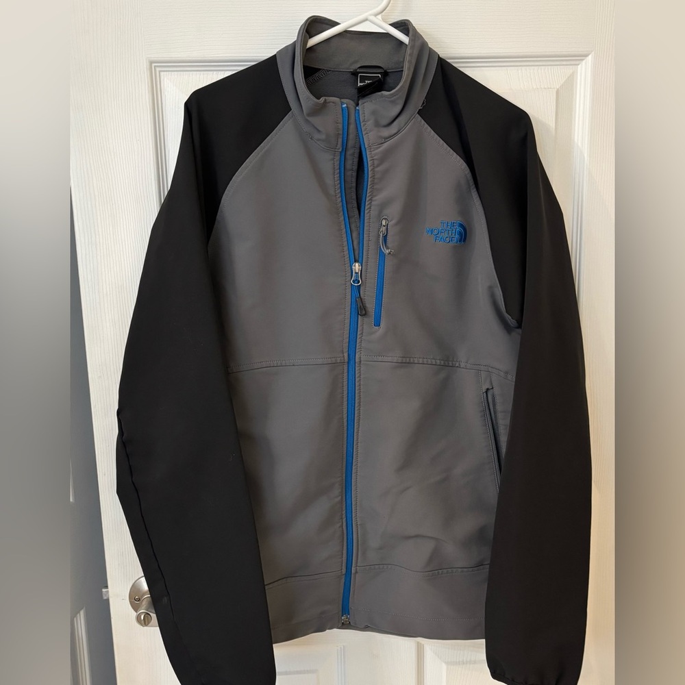 The North Face Men’s Gray Softshell Jacket with Black Sleeves and Blue Trim